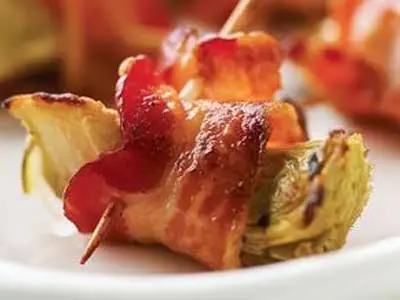 A plate of bacon wrapped food on top of a table.