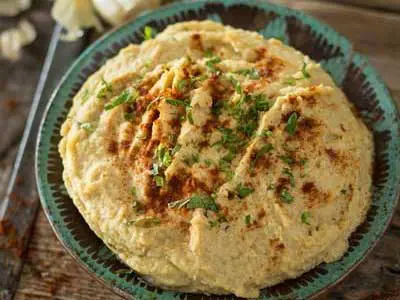 A plate of food with some type of meat on top.