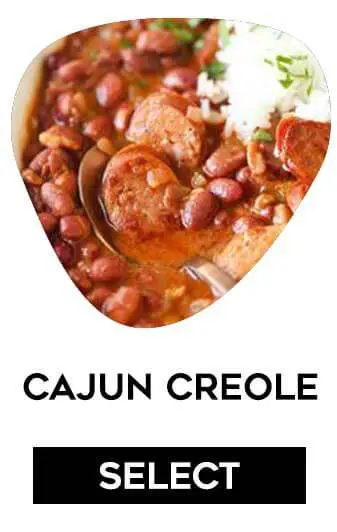 A bowl of cajun creole food with beans and sausage.