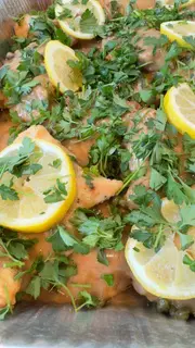 A close up of some food with lemon and parsley