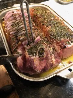 A large meat is being cut into it