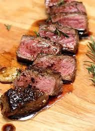 A close up of some meat on a cutting board